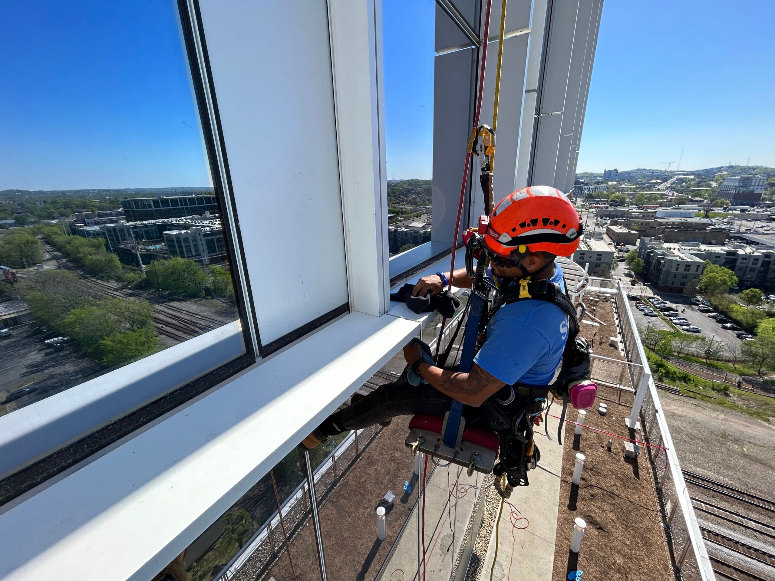 Window cleaning technician on a tall commercial building